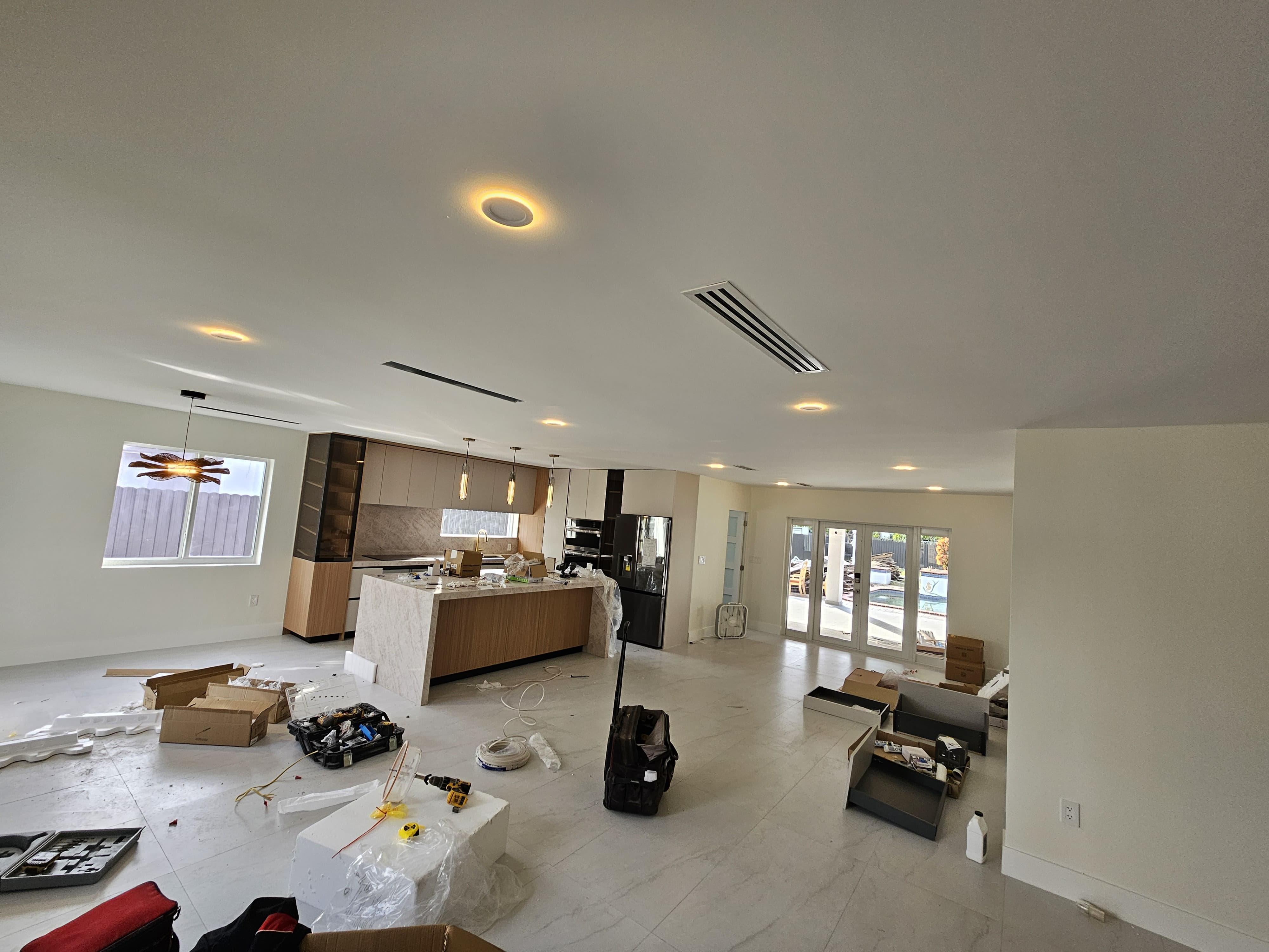 Modern kitchen with pendant and recessed lighting