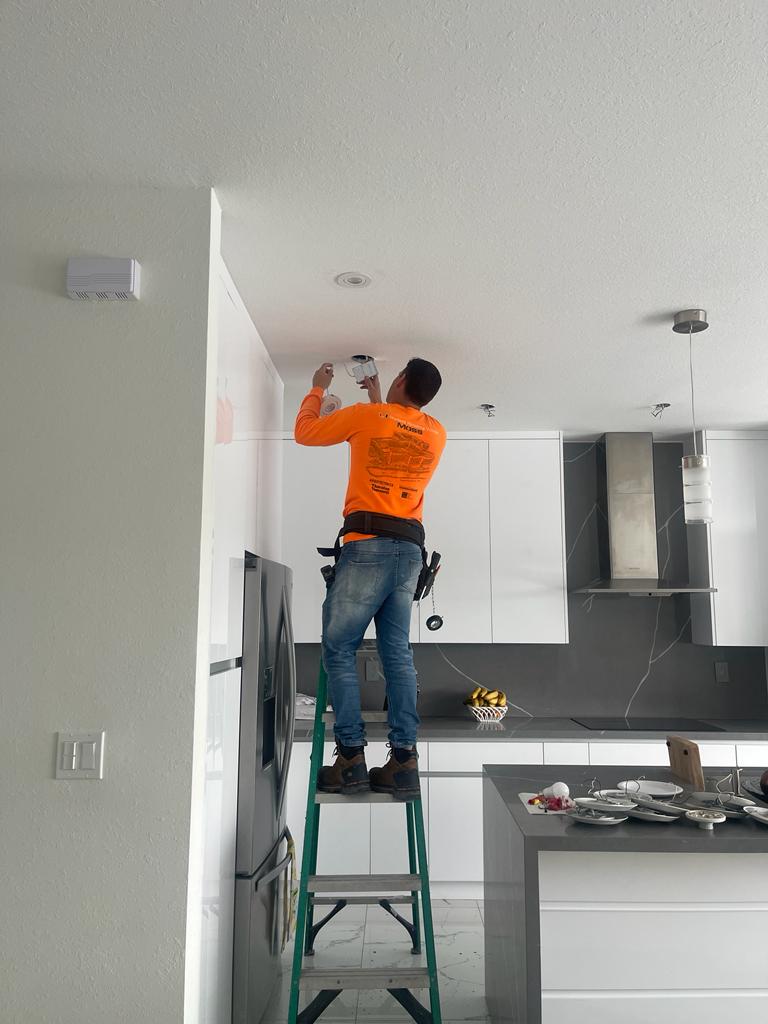 Technician installing a smart home device and security camera